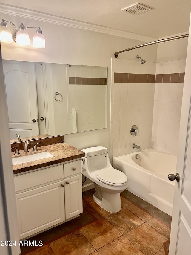 full bathroom with ornamental molding, toilet, vanity, and tiled shower / bath