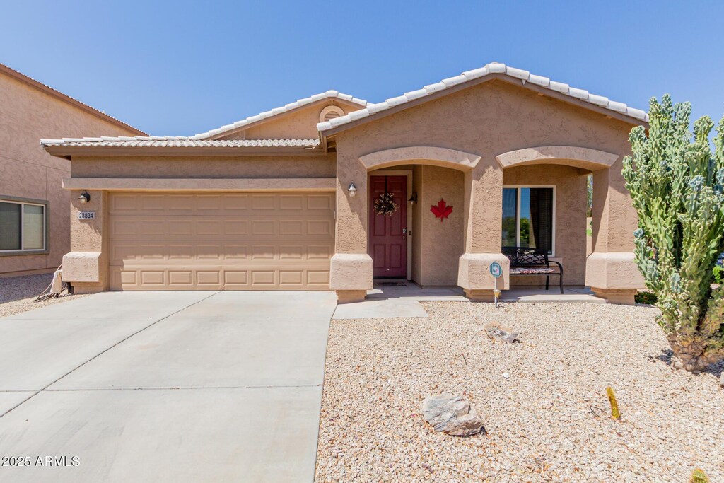 28834 N Spur Dr, San Tan Valley, AZ 85143 - view of front of house featuring an attached garage, driveway, and stucco siding