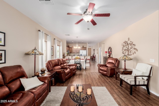 living room featuring a ceiling fan, wood finished floors, and visible vents