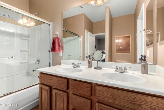 full bath with double vanity, visible vents, combined bath / shower with glass door, and a sink