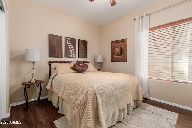 bedroom with baseboards, ceiling fan, and wood finished floors