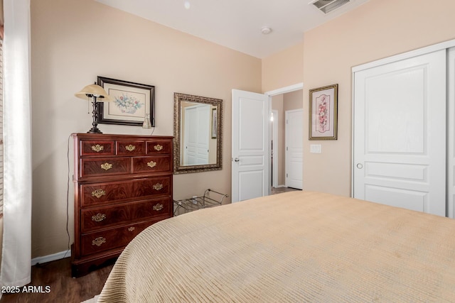 bedroom featuring baseboards, dark wood finished floors, and visible vents