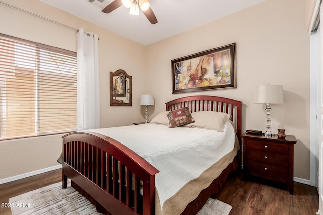 bedroom with baseboards, ceiling fan, wood finished floors, and visible vents