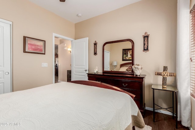 bedroom featuring baseboards, dark wood-style flooring, and ceiling fan