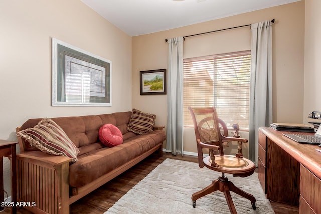 living area with baseboards and dark wood finished floors