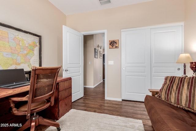 office area with visible vents, baseboards, and wood finished floors