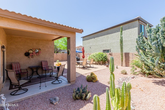 view of patio featuring fence