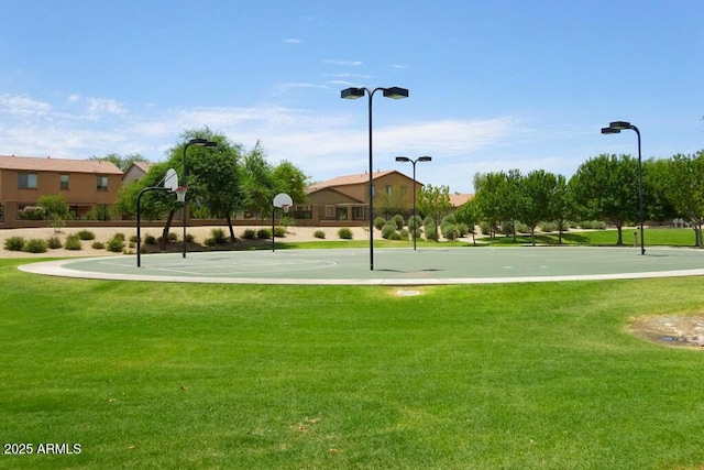 view of property's community featuring community basketball court and a yard
