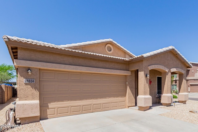 single story home featuring an attached garage, concrete driveway, and stucco siding