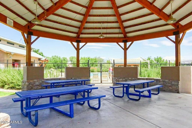view of patio / terrace featuring a gazebo, fence, and outdoor dining space