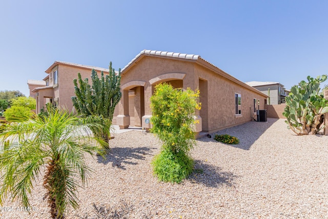 view of front of home featuring central air condition unit and stucco siding