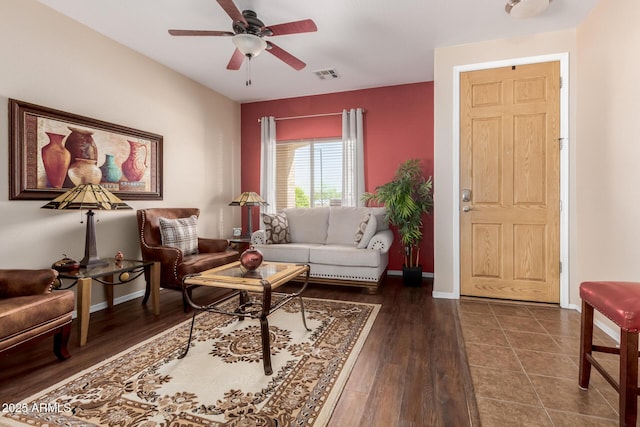 living area with baseboards, ceiling fan, wood finished floors, and visible vents