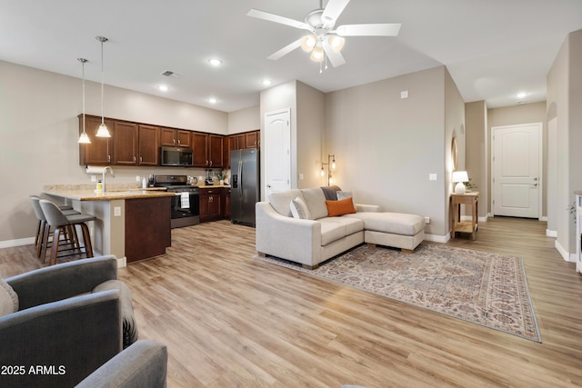 5524 N Brinson Ln, Prescott Valley, AZ 86314 - living room featuring light wood-type flooring, ceiling fan, baseboards, and recessed lighting