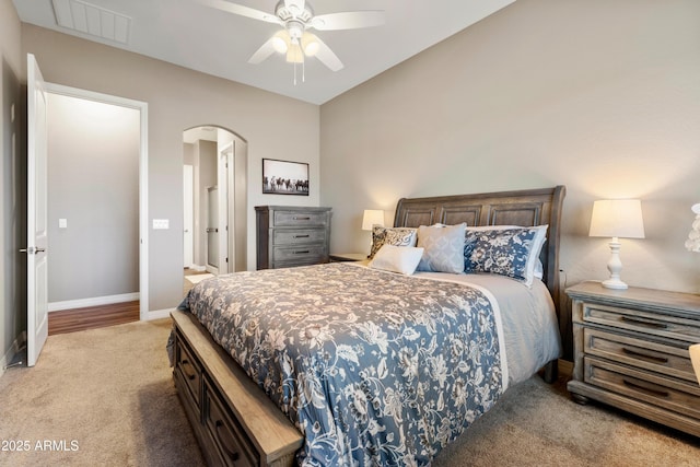 5524 N Brinson Ln, Prescott Valley, AZ 86314 - bedroom with light carpet, arched walkways, baseboards, and ceiling fan