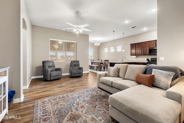 5524 N Brinson Ln, Prescott Valley, AZ 86314 - living room featuring light wood-style flooring, ceiling fan, baseboards, recessed lighting, and a chandelier