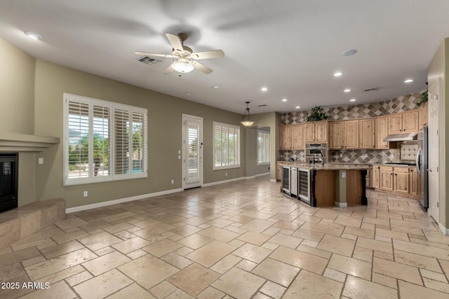 3531 E Norwood Cir, Mesa, AZ 85213 - kitchen featuring appliances with stainless steel finishes, recessed lighting, open floor plan, tasteful backsplash, and under cabinet range hood