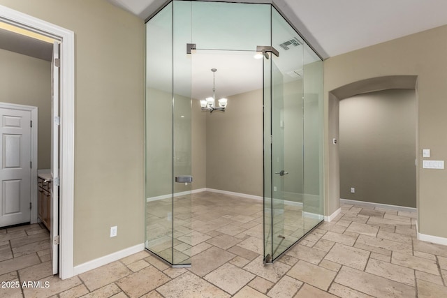 3531 E Norwood Cir, Mesa, AZ 85213 - empty room with stone tile flooring, a chandelier, and arched walkways