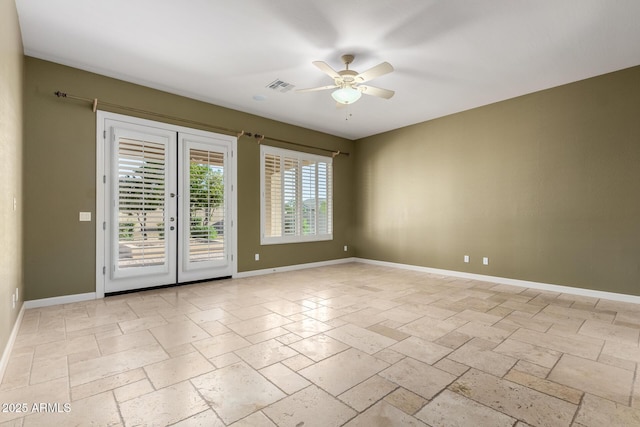 3531 E Norwood Cir, Mesa, AZ 85213 - unfurnished room featuring ceiling fan, stone tile flooring, and french doors