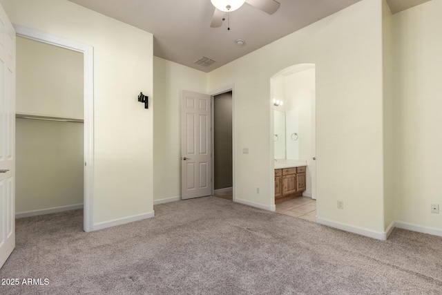 3531 E Norwood Cir, Mesa, AZ 85213 - unfurnished bedroom featuring light colored carpet, arched walkways, a closet, ensuite bathroom, and a spacious closet