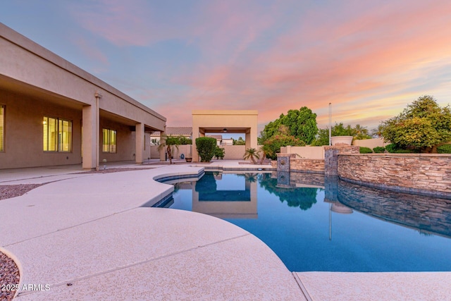 3531 E Norwood Cir, Mesa, AZ 85213 - pool at dusk featuring an outdoor pool, a patio area, and a fenced backyard