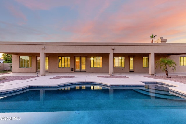 3531 E Norwood Cir, Mesa, AZ 85213 - pool at dusk featuring an outdoor pool and a patio