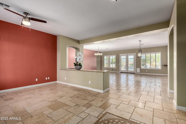 3531 E Norwood Cir, Mesa, AZ 85213 - empty room with stone tile flooring, ceiling fan, and a chandelier