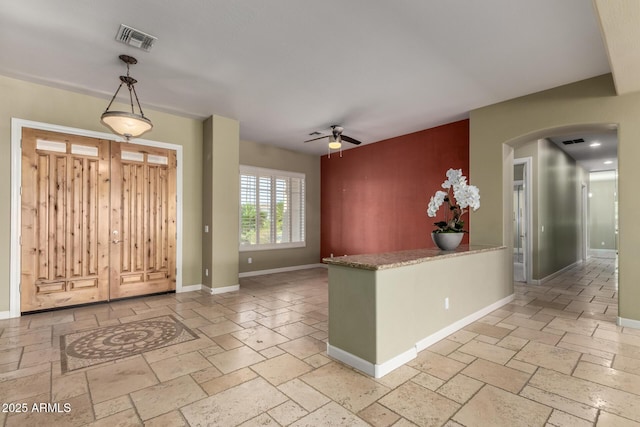 3531 E Norwood Cir, Mesa, AZ 85213 - foyer featuring arched walkways, stone tile flooring, and a ceiling fan