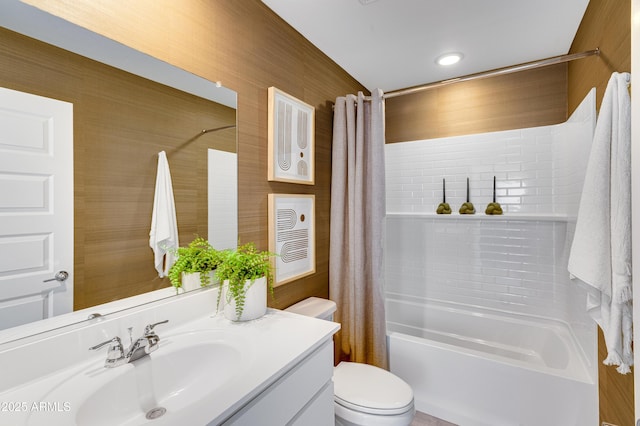 full bath with toilet, shower / bath combination with curtain, and vanity