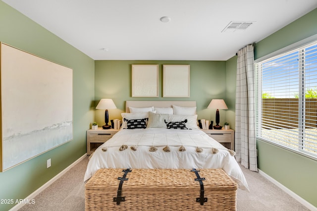bedroom featuring light carpet, baseboards, and visible vents