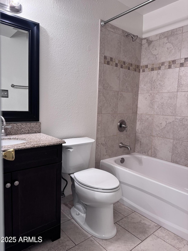 bathroom featuring shower / bathtub combination, a textured wall, toilet, vanity, and tile patterned flooring