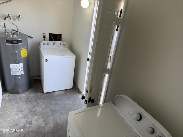 washroom with washer and dryer, laundry area, and water heater