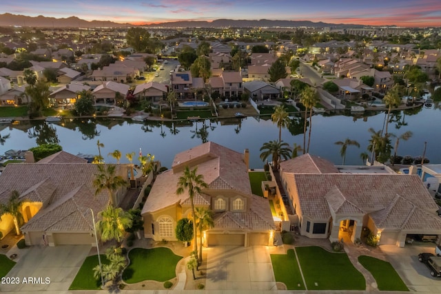 aerial view at dusk with a water view