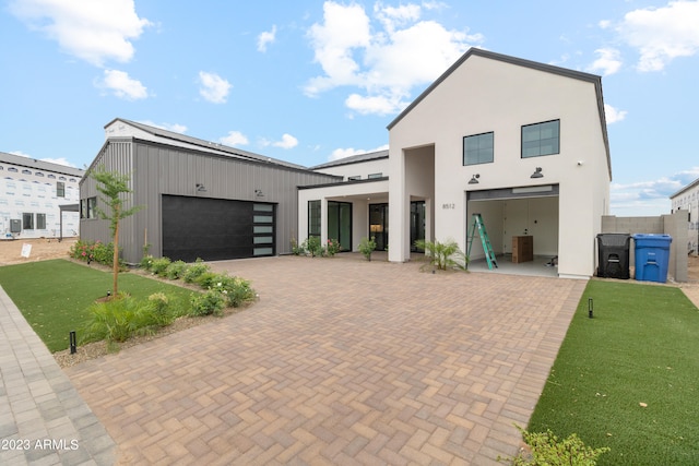 contemporary house featuring a garage and a front yard