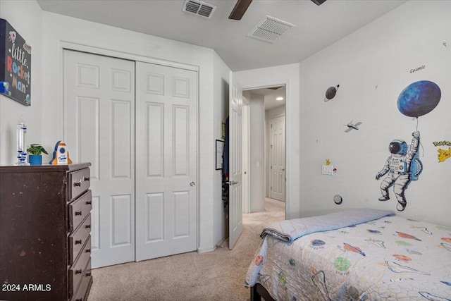 carpeted bedroom featuring ceiling fan and a closet