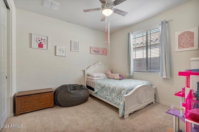 bedroom featuring ceiling fan, light colored carpet, and a closet