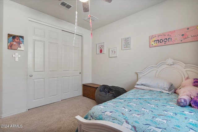 carpeted bedroom featuring a closet and ceiling fan