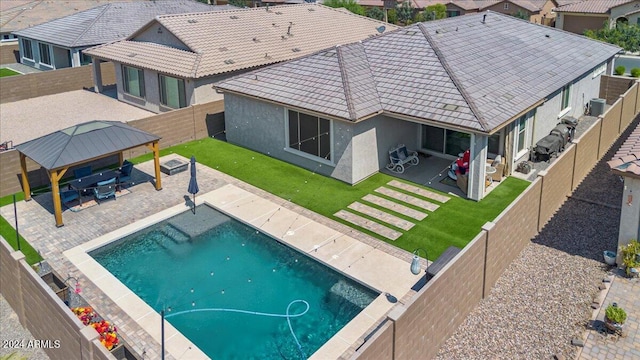 view of swimming pool featuring a gazebo, a yard, central AC, and a patio area