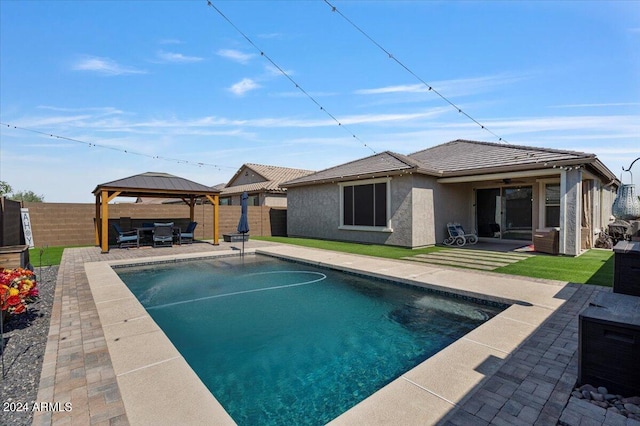 back of house with a fenced in pool, a gazebo, ceiling fan, and a patio