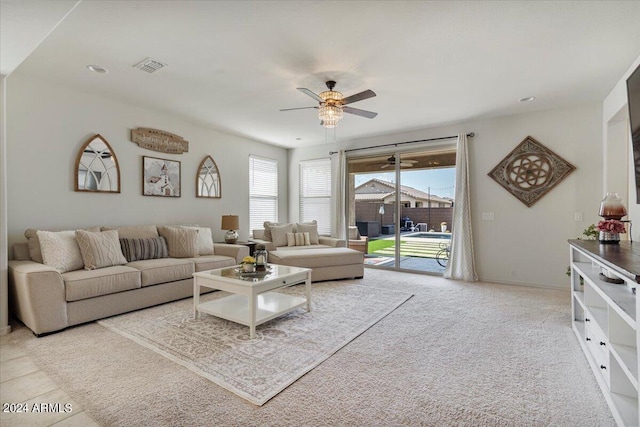 carpeted living room with ceiling fan