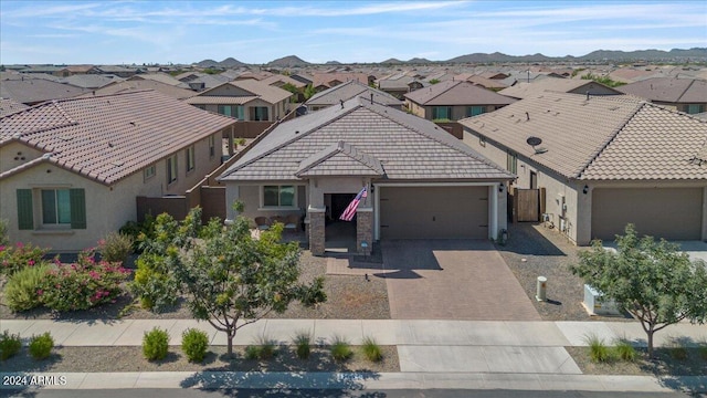 view of front of home with a mountain view and a garage