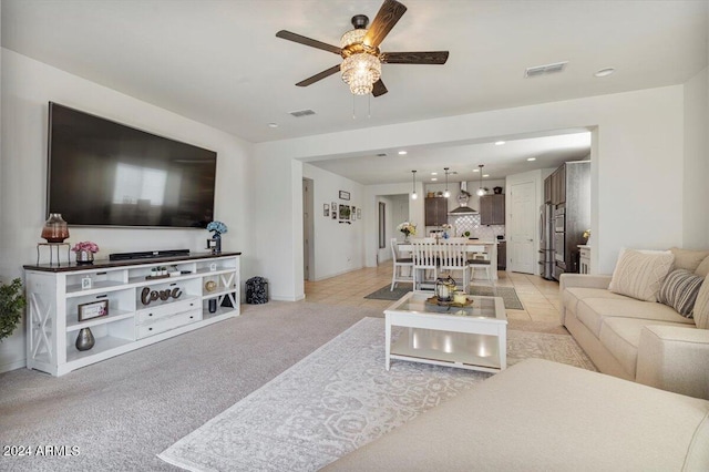 living room featuring light tile patterned floors and ceiling fan