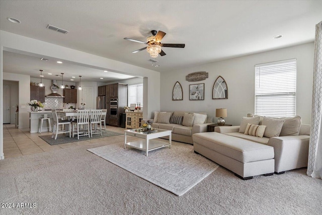 living room with ceiling fan and light tile patterned flooring