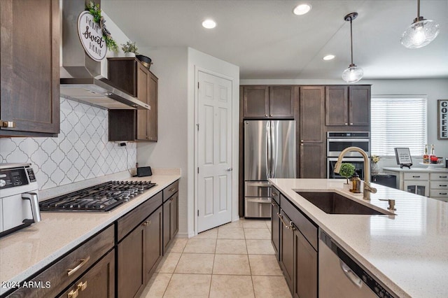 kitchen featuring light tile patterned flooring, sink, appliances with stainless steel finishes, pendant lighting, and backsplash