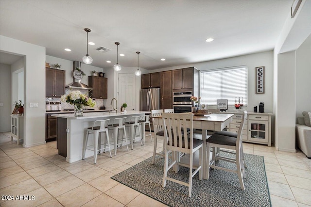 dining space with light tile patterned flooring and sink