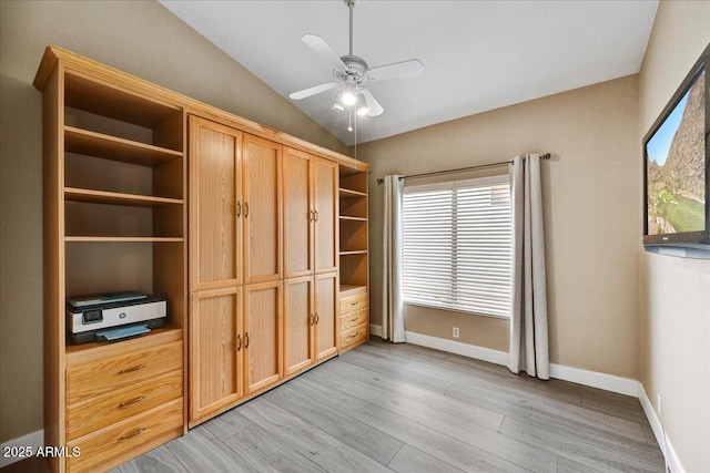 unfurnished bedroom with ceiling fan, lofted ceiling, and light wood-type flooring