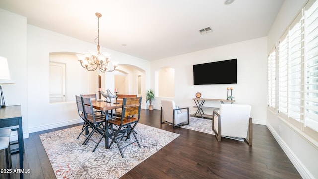 dining room featuring a notable chandelier and dark hardwood / wood-style floors