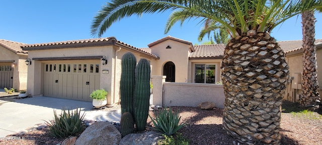 mediterranean / spanish home with a garage