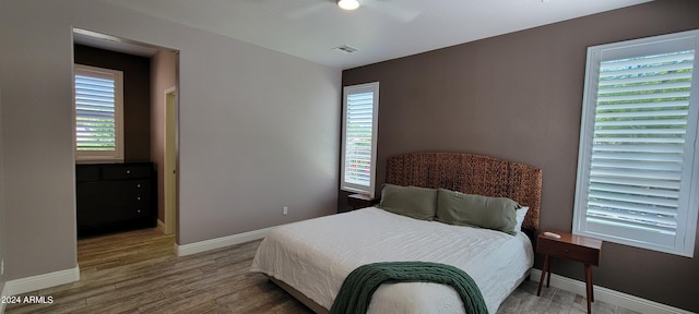 bedroom with wood-type flooring and ceiling fan