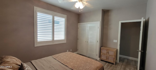 bedroom featuring a closet, hardwood / wood-style floors, and ceiling fan