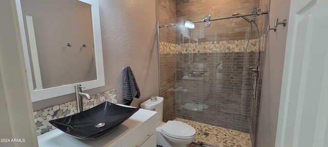 bathroom with toilet, an enclosed shower, and vanity